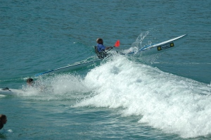 Surf ski riding wave