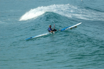 Surf ski riding wave