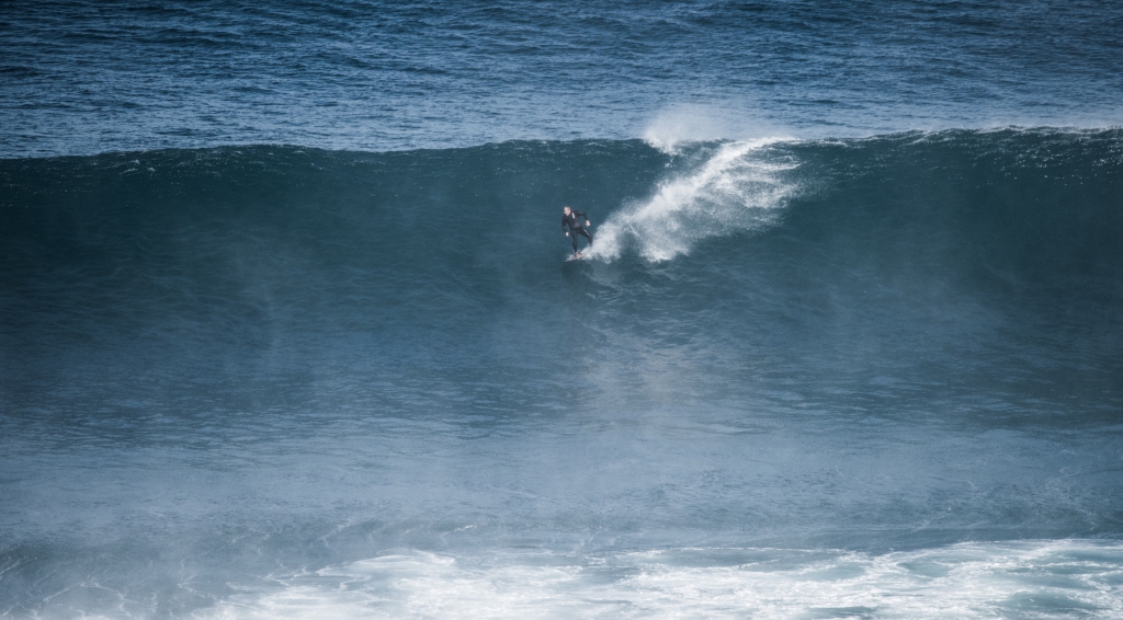 Surfer riding large wave at Two Mile